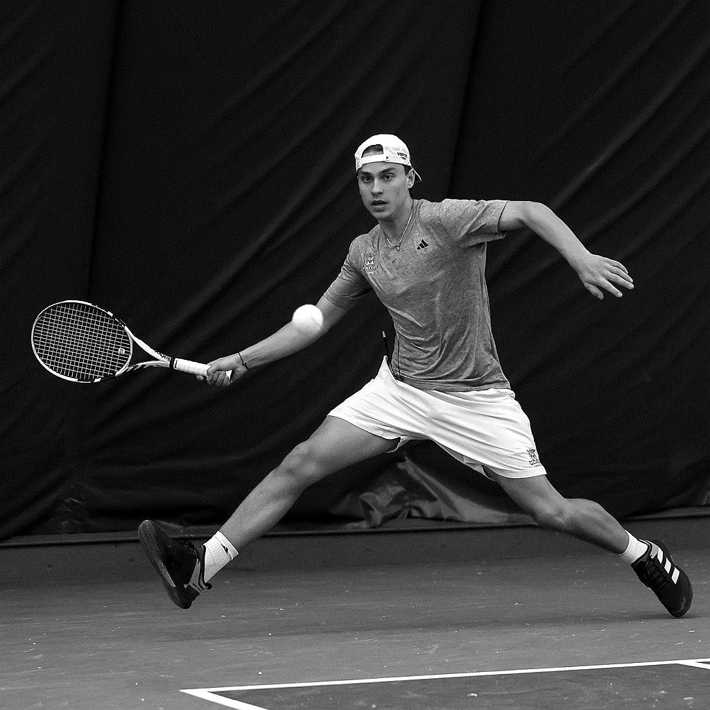 Sebastian lunging for a forehand at Weber State